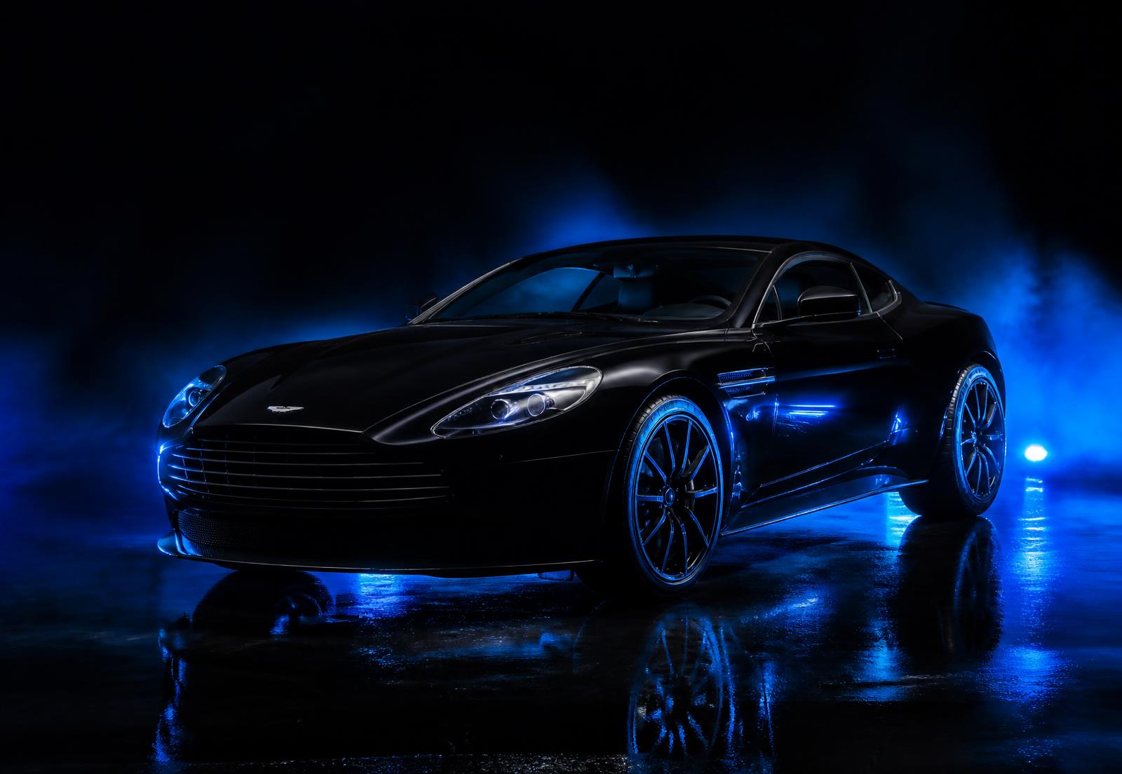 Black luxury car with a ceramic coated gloss finish in a dark studio